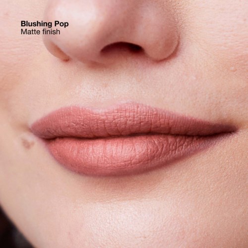 Close-up of lips with matte finish lipstick, natural skin texture visible.