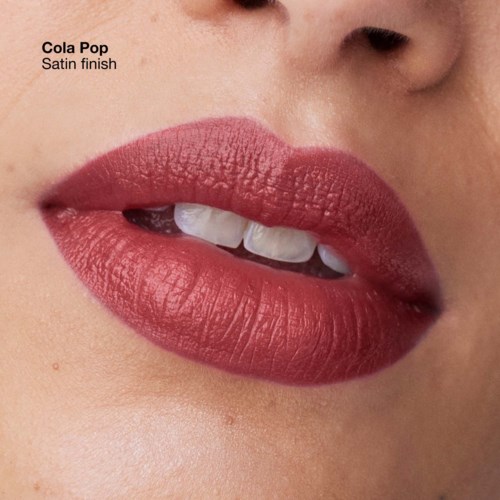 Close-up of lips with lipstick, showing teeth, natural skin, and a small part of the nose.
