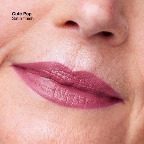 Close-up van lippen met roze lippenstift, toont textuur. Tekst zegt 'Cute Pop Satin finish'.