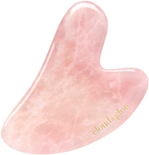 Een roze jaspis gua sha-tool met de woorden 'cloud & glow' in goud.