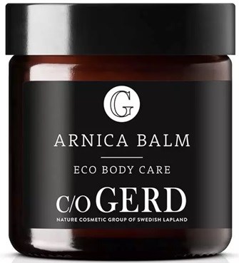 A jar labeled Arnica Balm, eco body care, by c/o GERD, from Swedish Lapland, with a black lid and dark container.