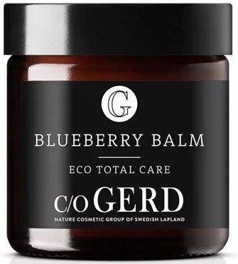 A jar labeled 'Blueberry Balm' by GO GERD, black and white design, suggests skincare or cosmetic product.