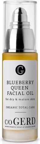 A small bottle of blueberry queen facial oil with a yellow liquid inside and a white label.