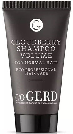 A black tube labeled 'Cloudberry Shampoo Volume' for normal hair, with eco and professional hair care details.
