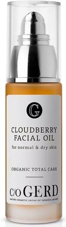 A bottle of cloudberry facial oil on a white background, labeled for normal and dry skin, with organic ingredients.