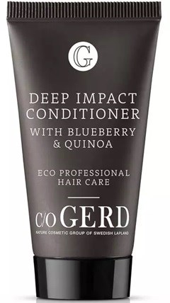 A black tube with white text promoting a deep impact conditioner with blueberry and quinoa for hair care.