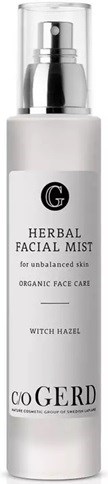 A white bottle with a pump labeled 'Herbal Facial Mist' for skin, containing witch hazel and organic face care.