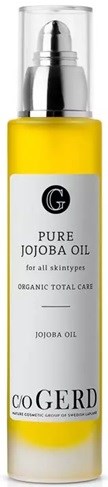 A yellow bottle with a silver cap and a label that says 'Pure Jojoba Oil' for skin care.