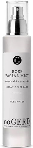 A white bottle labeled 'Rose Facial Mist' for normal skin, containing organic rose water, with a pump spray top.