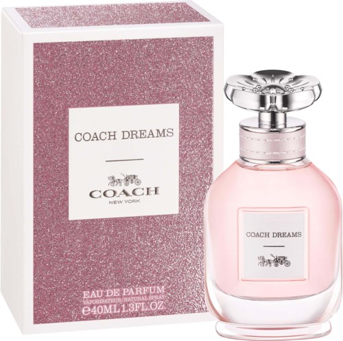 A pink perfume bottle with a silver cap and a matching pink box labeled Coach Dreams.