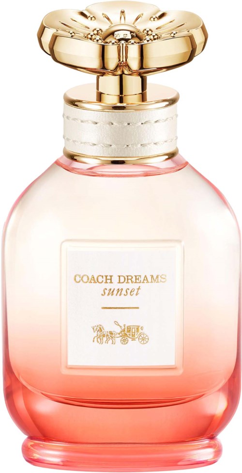 A perfume bottle with pink liquid, a white label, and a gold cap shaped like a flower.