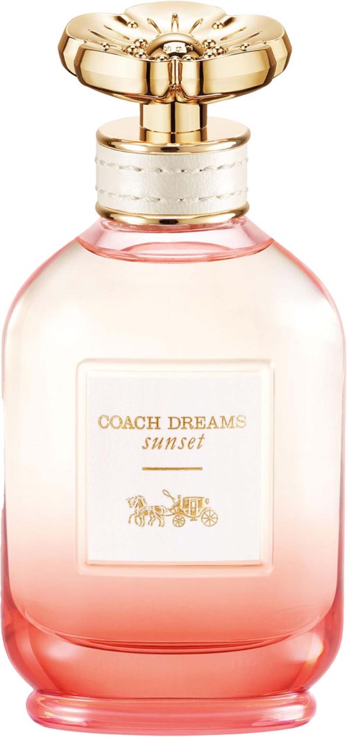 A pink perfume bottle with a gold and white cap, labeled Coach Dreams Sunset, featuring a carriage illustration.