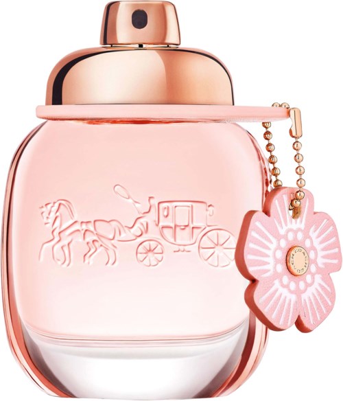 A pink perfume bottle with a rose gold cap, decorated with a flower charm and engraved horse and carriage.