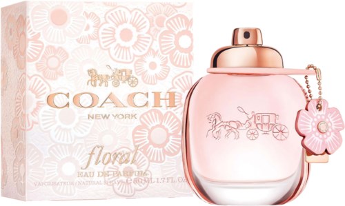 A pink Coach perfume bottle with a rose charm and horse-drawn carriage logo, beside a floral patterned box.