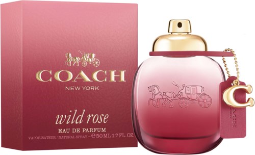 Pink Coach perfume bottle with a gold cap and a small charm, next to a matching pink box.