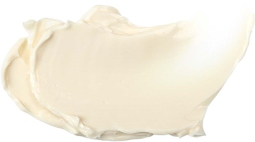 A dollop of white cream or frosting on a black background.