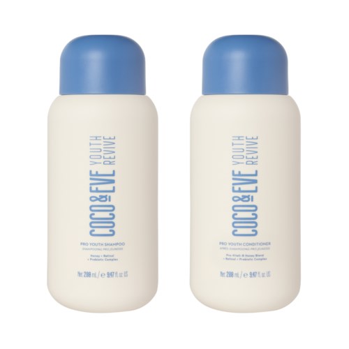 Two white bottles with blue caps, labeled 'Coco & Eve Youth Revive' shampoo and conditioner, placed side by side.