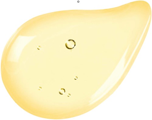 A splash of yellow oil with bubbles inside, smooth and shiny surface.