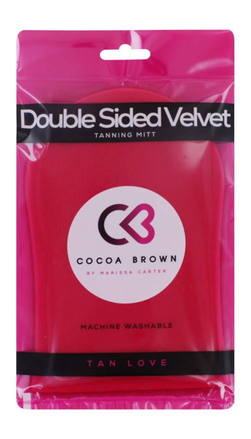 Pinkfarbener Selbstbräunungshandschuh mit schwarzen Bändern, weißem Kreislogo und Text: 'Double Sided Velvet', 'Cocoa Brown', 'Tan Love'.