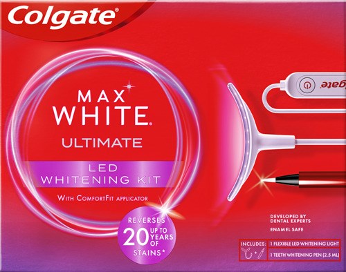 Red and purple box for Colgate Max White Ultmate LED whitening set, showing a whitening light device and a pen.
