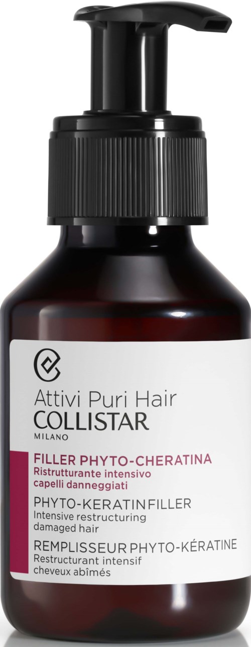 Een donkerbruine fles met een zwarte pomp en een witte label met productgegevens voor haarverzorging.