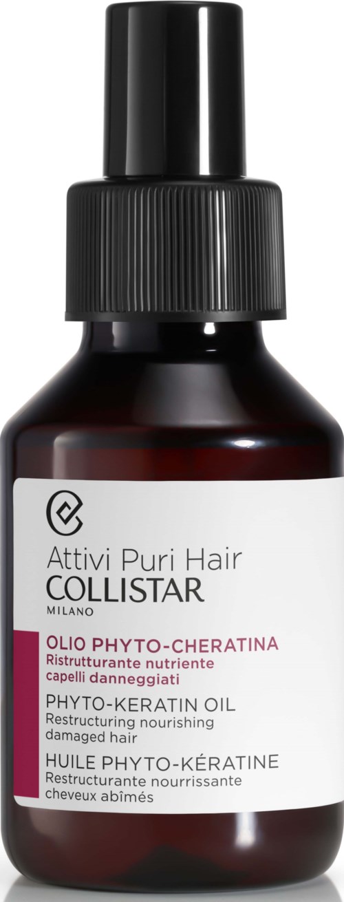 A small brown bottle with a black spray cap, labeled with product details in multiple languages for hair care.