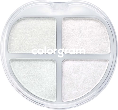 En rund sminkpalette med fire hvite pulverseksjoner og gjennomsiktig lokk, merket "color gram."