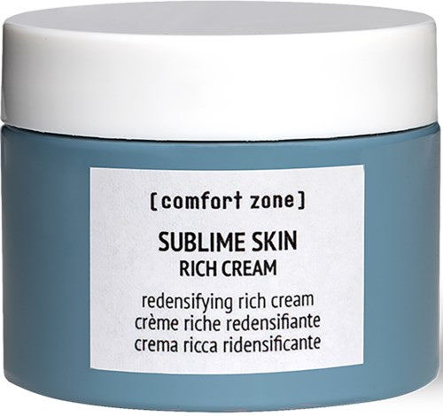 Ett blått burk med vit lock och etikett, innehållande Sublime Skin Rich Cream för hudfuktning.