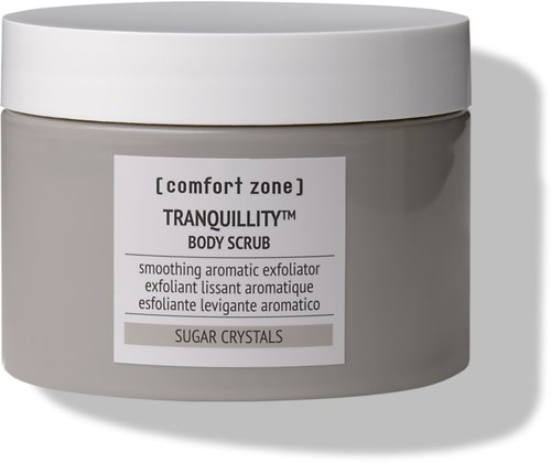 A gray jar labeled 'Tranquillity Body Scrub' with a white lid, containing sugaring crystals for smoothing skin.