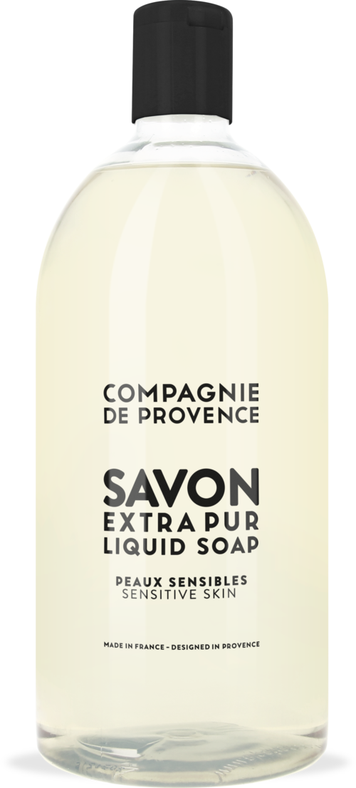 Clear bottle of gentle liquid soap for sensitive skin from France. Simple black and white label with product details.