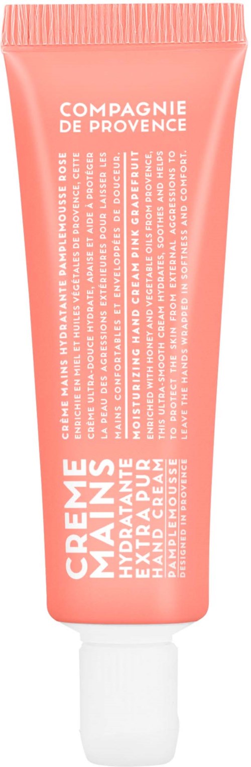 A pink tube of hand cream from Compagnie de Provence with white text, standing upright with a white cap.