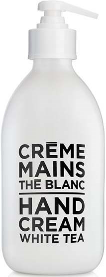 A white bottle with a pump, labeled 'Hand Cream White Tea' and 'Crème Mains The Blanc'.