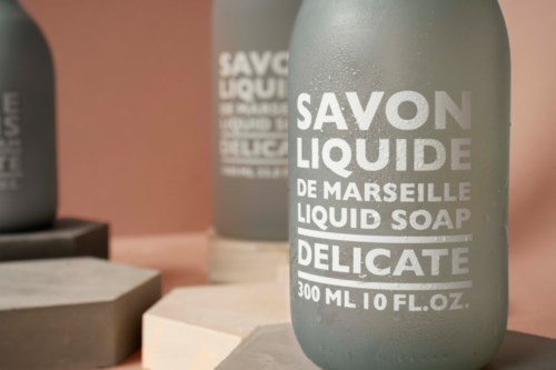 Gray bottles of liquid soap labeled 'Savon Liquide de Marseille, Liquid Soap, Delicate, 300 ml.'