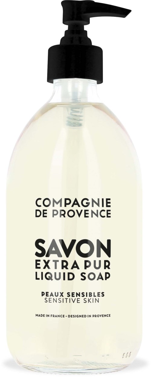 A clear liquid soap in a transparent bottle with a black pump, labeled for sensitive skin. Made in France.