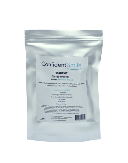 A silver pack with a white label named 'Confident Smile' for teeth whitening, featuring product details and instructions.