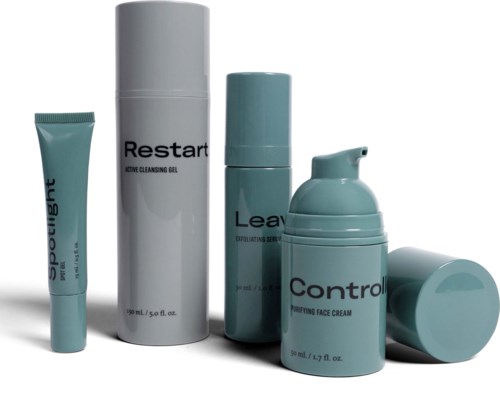 A set of skincare products includes a tube, a large bottle, a smaller bottle, a pump container, and a jar.