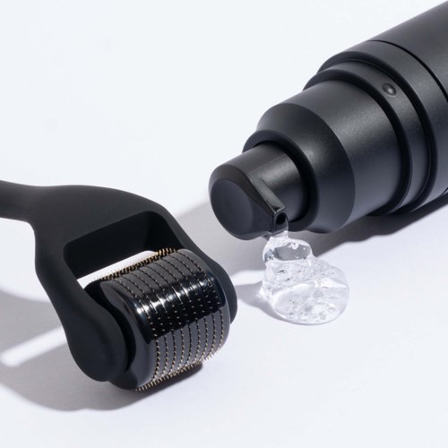 A black facial roller, a black bottle dispensing a gel or serum, both on a white background.