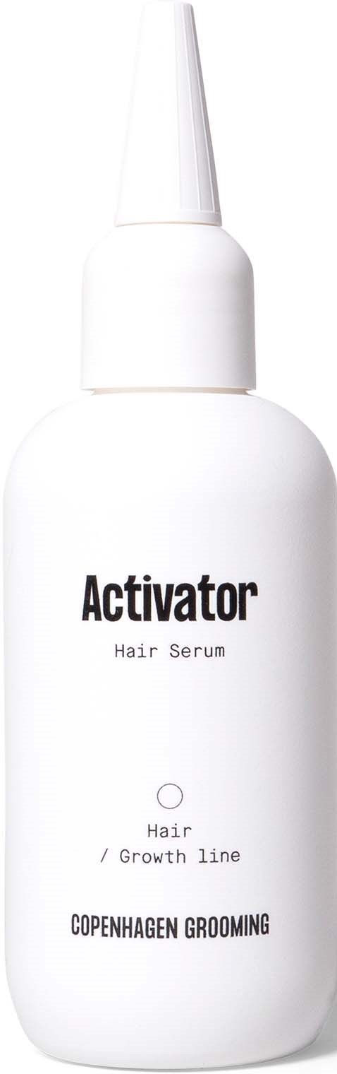 A white bottle of hair serum labeled 'Activator' with a pointed cap from Copenhagen Grooming.