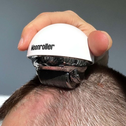 A device labeled 'Moonroller' presses on a person's scalp, likely for massaging or skin care purposes.