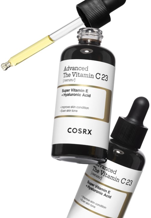 Een fles huidserum met pipet en een kleinere fles, beide gelabeld met vitamine C en hyaluronzuur.