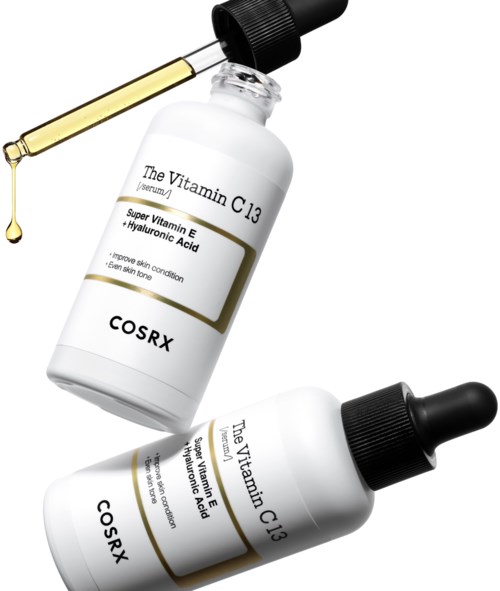 Een huidverzorgingsserumfles met vitamine C3 en hyaluronzuur, met een pipet die een druppel olie afgeeft.