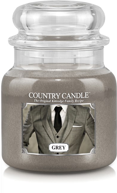 A grey candle in a glass jar with a label of a man in a suit and the word 'GREY'.