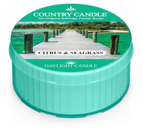 Round candle with a label that says Citrus & Seagrass, showing a dock over water and trees. It is a daylight candle.