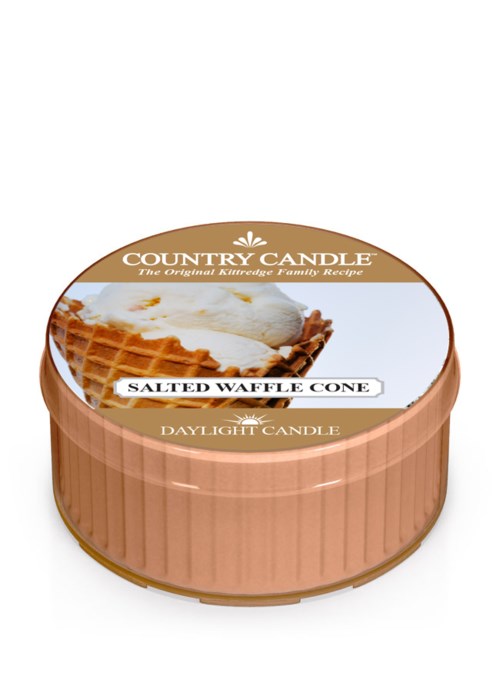 A candle in a round container with a label showing salted waffle cone flavor and a waffle with ice cream image.