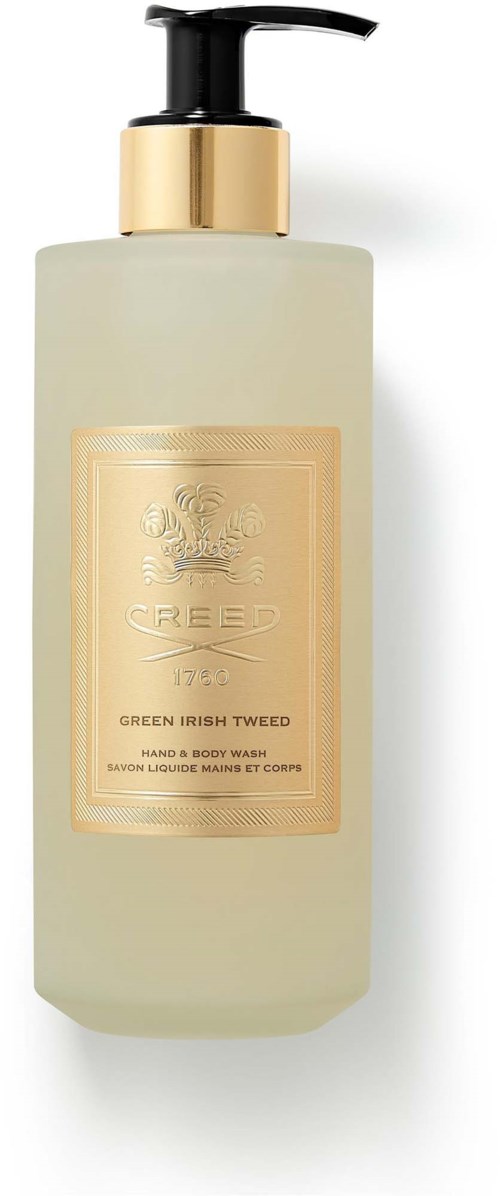 Beige flaske med svart pumpe, gullgjerne og en etikett som leser 'Creed Green Irish Tweed' for hånd- og kroppsvask.