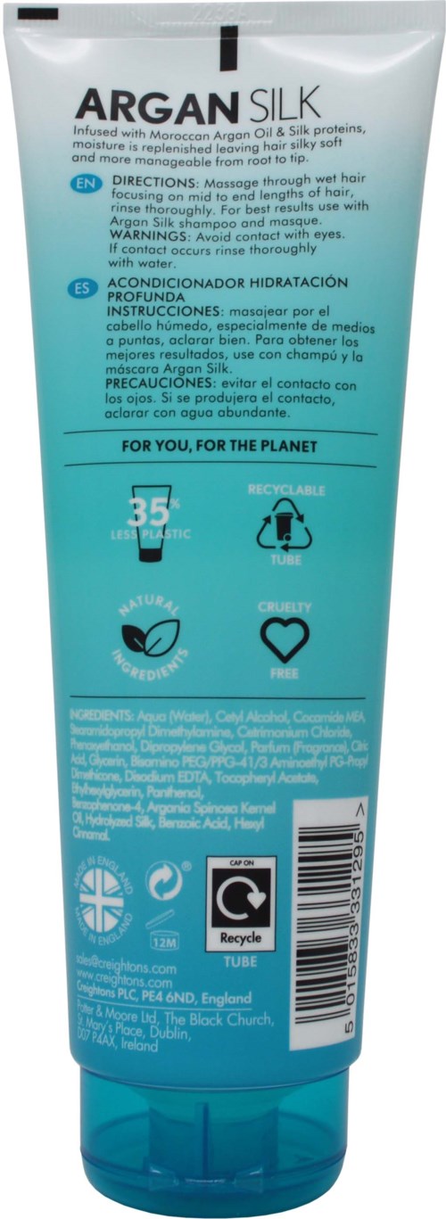 A blue and white tube of Argansilk hair conditioner with instructions and symbols on the back.