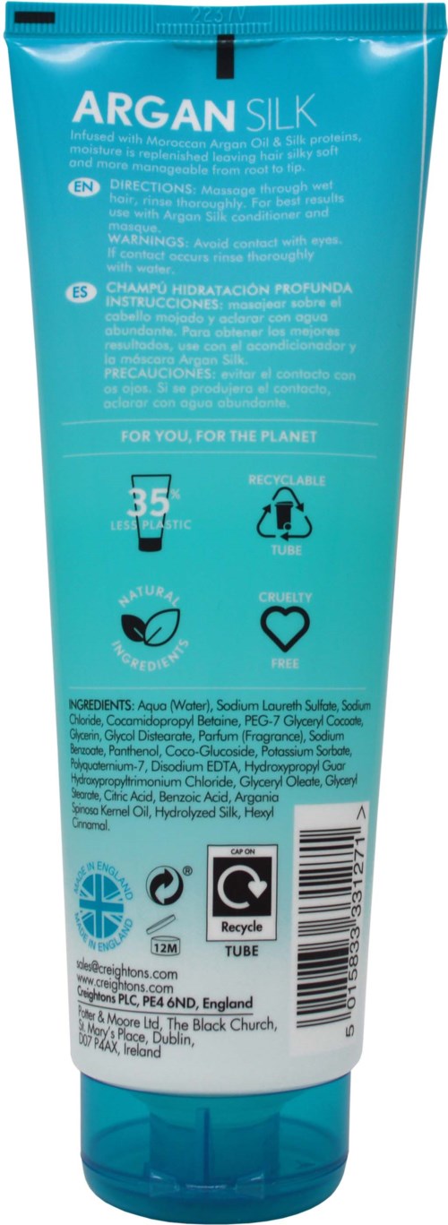A blue tube of Argan Silk hair conditioner with instructions and symbols on the back.
