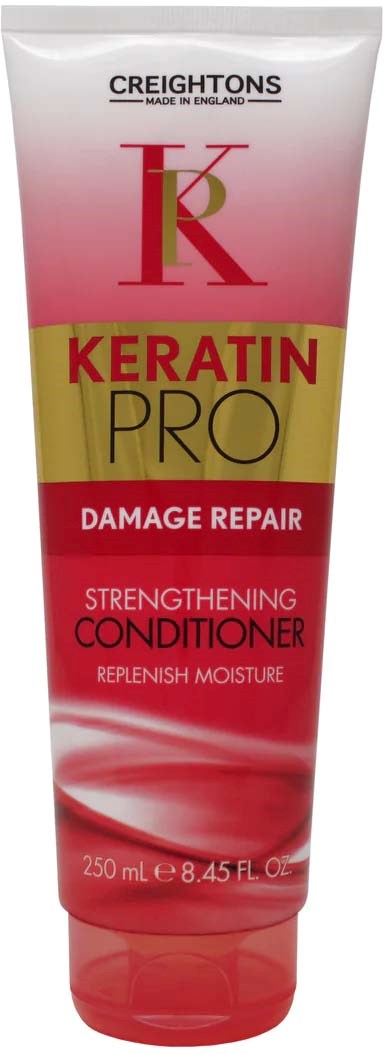 A hair conditioner tube labeled 'Keratin Pro' for damage repair and strength, with pink, gold, and red colors.