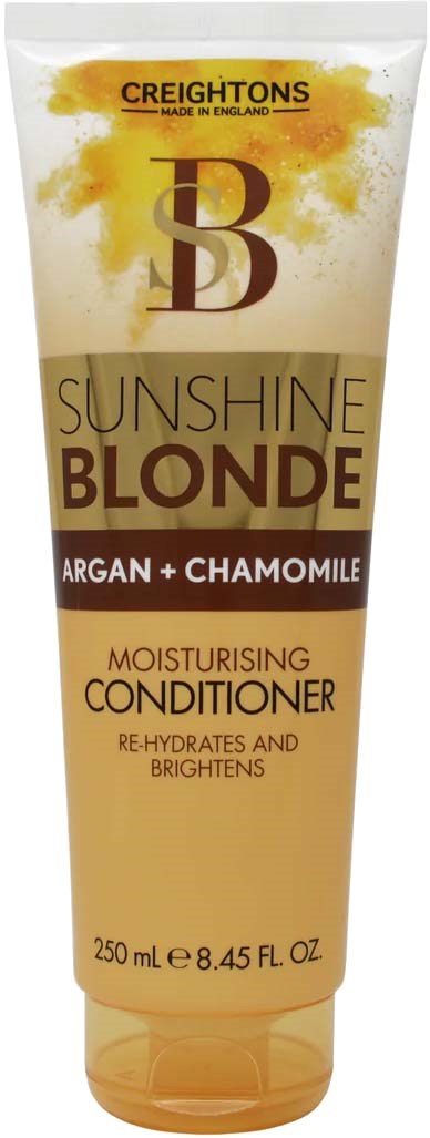 A tube of hair conditioner with yellow and brown colors, labeled as moisturizing with argan and chamomile for blondes.
