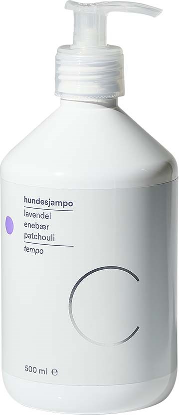 A white bottle with a pump, labeled for dog shampoo with lavender, chamomile, and patchouli ingredients, 500 ml.